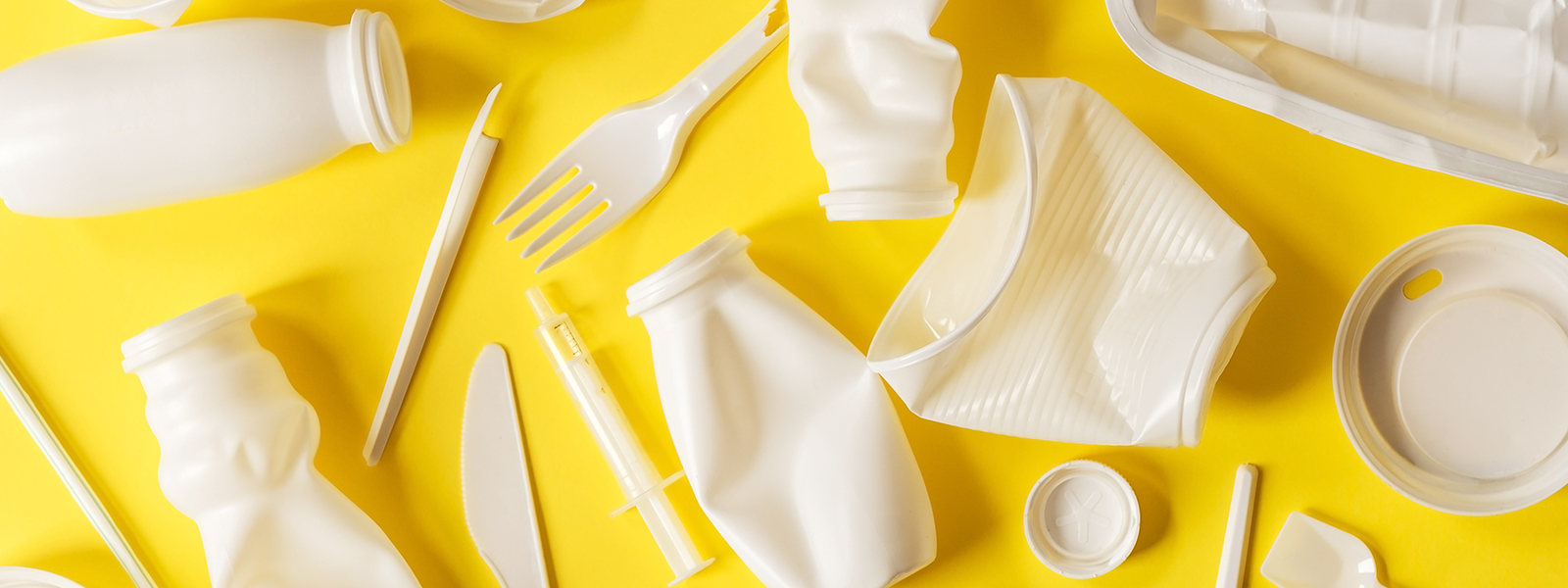 Single use plastic on a yellow background